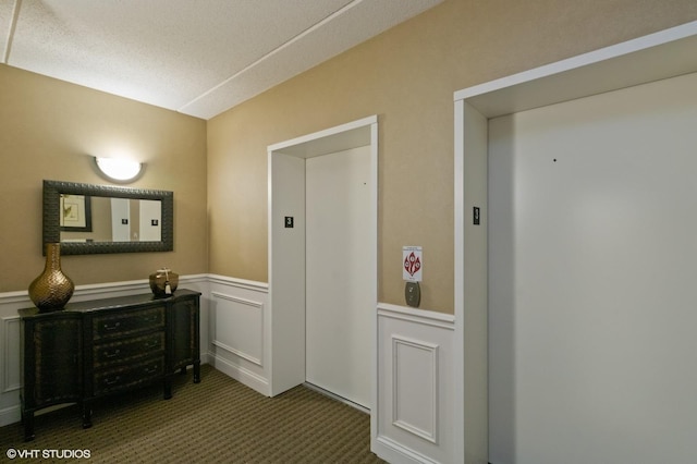 50 S Greeley St Unit 314, Palatine, IL 60067 - corridor featuring elevator, a wainscoted wall, carpet flooring, and a decorative wall