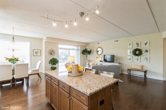 50 S Greeley St Unit 314, Palatine, IL 60067 - kitchen with stainless steel appliances, brown cabinets, crown molding, and a textured ceiling