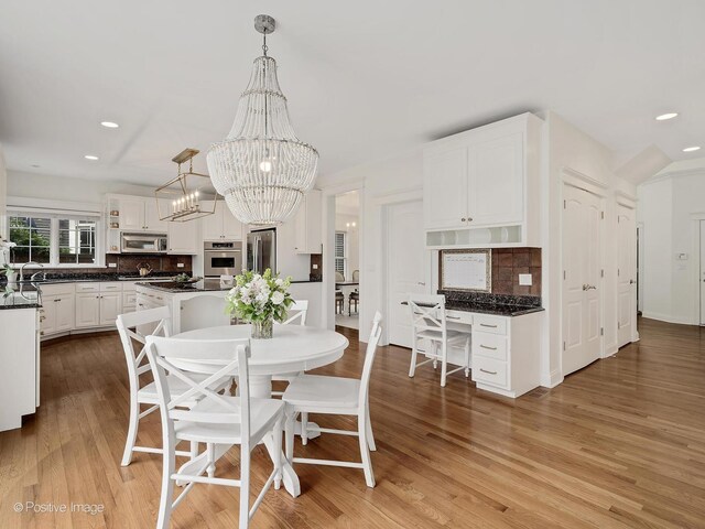 551 W 3rd St, Elmhurst, IL 60126 - dining space with a chandelier, recessed lighting, and light wood-type flooring