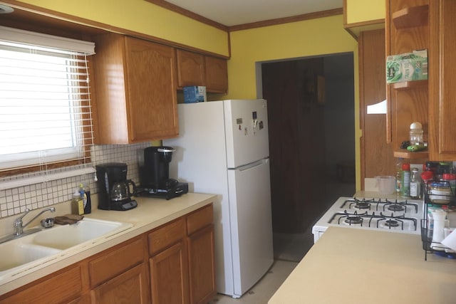 15153 Harding Ave, Midlothian, IL 60445 - kitchen featuring light countertops, brown cabinets, backsplash, freestanding refrigerator, and crown molding