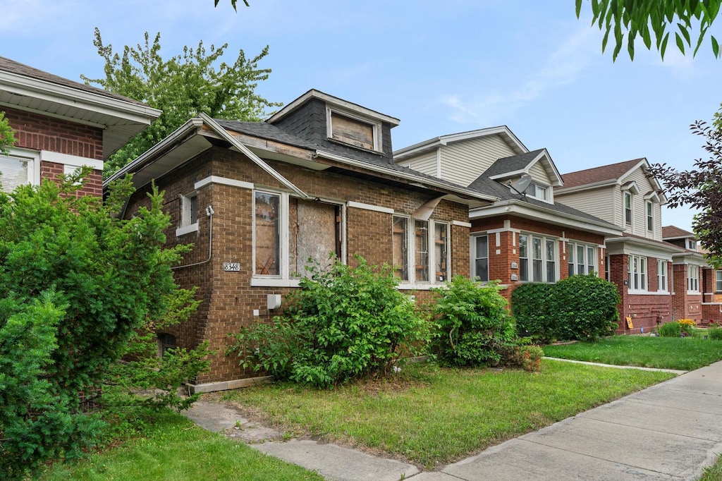 8348 S Oglesby Ave, Chicago, IL 60617 - view of front of house with brick siding and a front lawn
