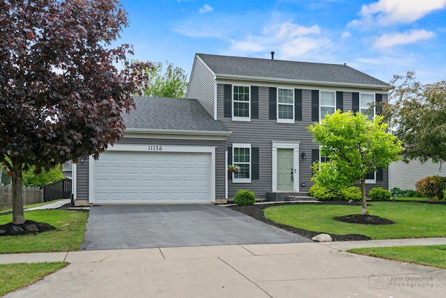 11176 Fleetwood St, Huntley, IL 60142 - colonial-style house featuring driveway, a garage, and roof with shingles