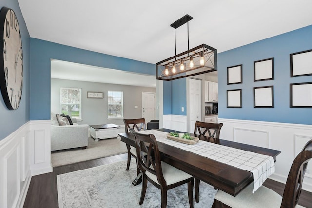11176 Fleetwood St, Huntley, IL 60142 - dining room with wainscoting, dark wood-style flooring, and a decorative wall