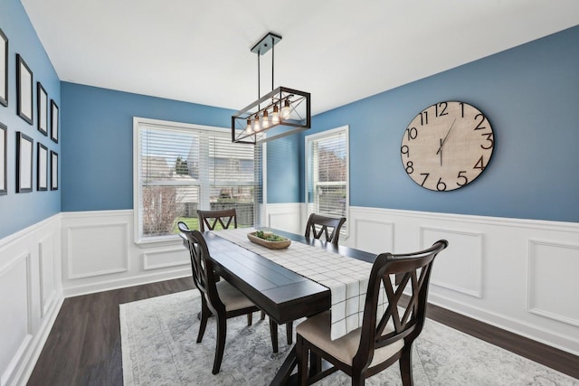11176 Fleetwood St, Huntley, IL 60142 - dining space with a chandelier, a wainscoted wall, dark wood-type flooring, and a decorative wall