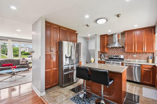 9342 Oriole Ave, Morton Grove, IL 60053 - kitchen with wall chimney range hood, appliances with stainless steel finishes, backsplash, light stone counters, and a center island