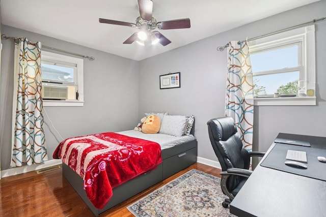 9342 Oriole Ave, Morton Grove, IL 60053 - bedroom with multiple windows, wood finished floors, cooling unit, and a desk