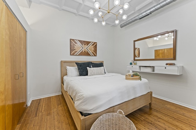 1307 S Wabash Ave Unit 413, Chicago, IL 60605 - bedroom with wood finished floors, a chandelier, coffered ceiling, and beam ceiling