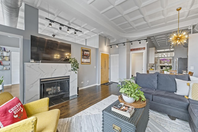 1307 S Wabash Ave Unit 413, Chicago, IL 60605 - living room featuring wood finished floors, rail lighting, a fireplace, and a chandelier