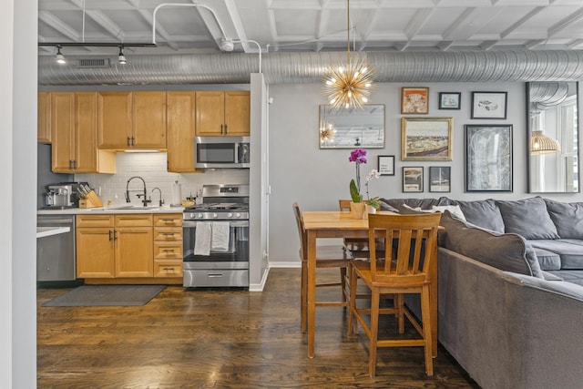 1307 S Wabash Ave Unit 413, Chicago, IL 60605 - kitchen featuring appliances with stainless steel finishes, open floor plan, light countertops, dark wood finished floors, and track lighting