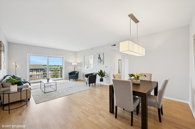 11 S Wille St Unit 709, Mount Prospect, IL 60056 - dining space featuring light wood-type flooring and baseboards