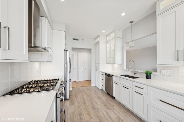 11 S Wille St Unit 709, Mount Prospect, IL 60056 - kitchen with appliances with stainless steel finishes, wall chimney exhaust hood, white cabinets, glass insert cabinets, and tasteful backsplash