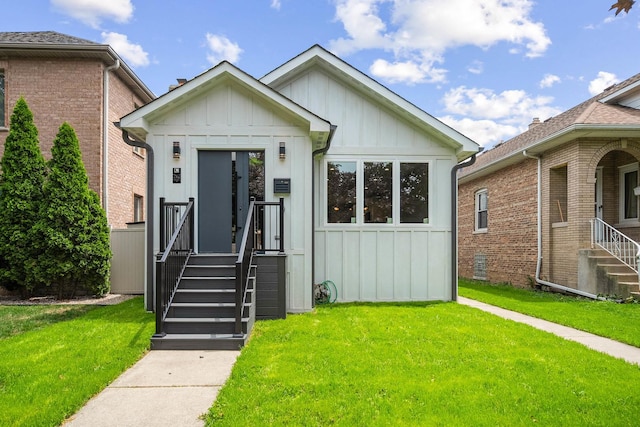 2563 Maple St, River Grove, IL 60171 - view of front of house with board and batten siding and a front yard