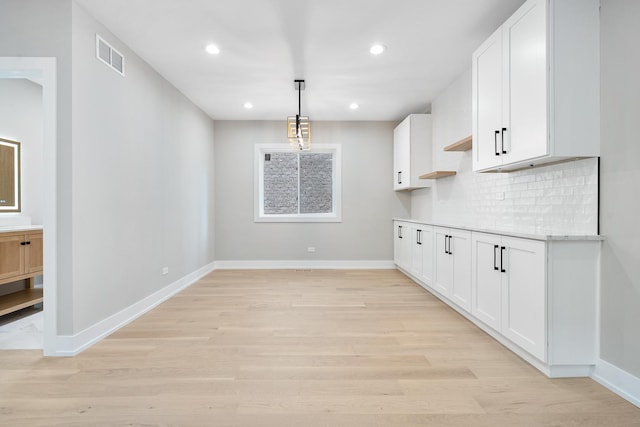 2563 Maple St, River Grove, IL 60171 - kitchen featuring white cabinets, decorative backsplash, light wood-type flooring, and recessed lighting