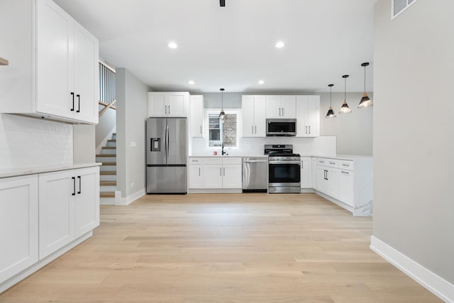 2563 Maple St, River Grove, IL 60171 - kitchen featuring stainless steel appliances, tasteful backsplash, light countertops, white cabinetry, and recessed lighting