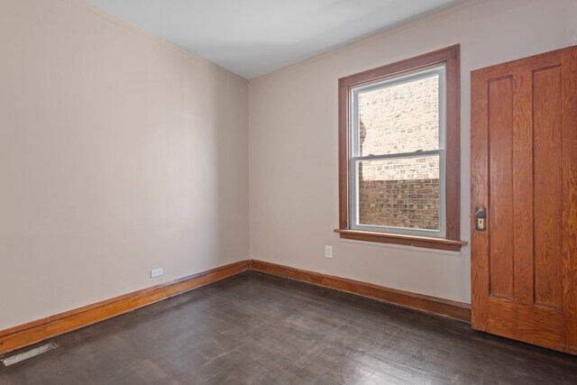 5407 S Justine St, Chicago, IL 60609 - empty room with dark wood-style floors and ornamental molding