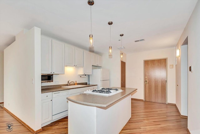 910 S Michigan Ave Unit 1712, Chicago, IL 60605 - kitchen featuring white appliances, light wood-type flooring, white cabinetry, a center island, and pendant lighting