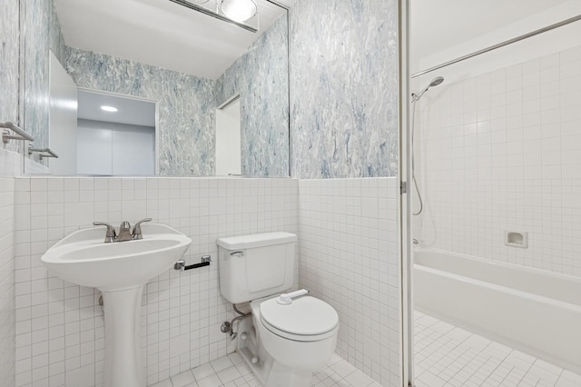 40 E 9th St Unit 1609, Chicago, IL 60605 - full bathroom featuring tile patterned floors, tile walls, washtub / shower combination, wallpapered walls, and wainscoting