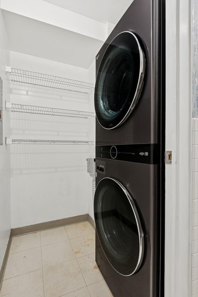 40 E 9th St Unit 1609, Chicago, IL 60605 - washroom featuring estacked washer and dryer and light tile patterned floors