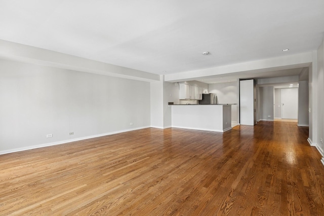 40 E 9th St Unit 1609, Chicago, IL 60605 - unfurnished living room featuring wood finished floors and baseboards