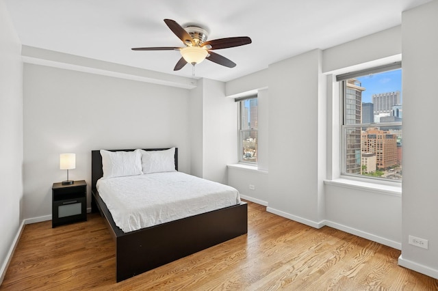 40 E 9th St Unit 1609, Chicago, IL 60605 - bedroom with wood finished floors, a view of city, and ceiling fan