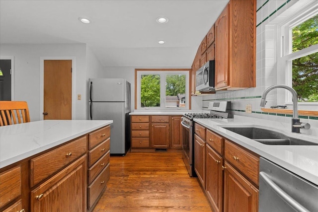 1719 Ferndale Ave, Northbrook, IL 60062 - kitchen with appliances with stainless steel finishes, brown cabinetry, wood finished floors, recessed lighting, and light stone countertops