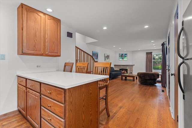 1719 Ferndale Ave, Northbrook, IL 60062 - kitchen featuring a peninsula, a breakfast bar area, light wood-type flooring, recessed lighting, and light countertops