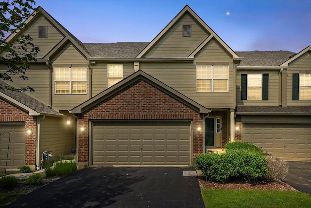 5227 Cobblers Xing Unit 5227, Mchenry, IL 60050 - view of front facade with brick siding, driveway, and an attached garage