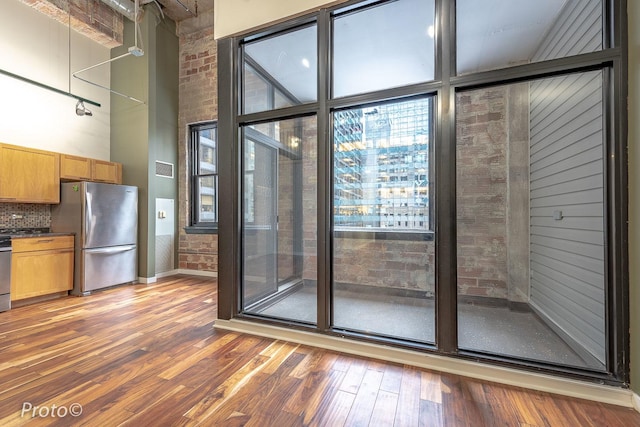 20 N State St Unit 1012, Chicago, IL 60602 - interior space featuring light wood-type flooring, a high ceiling, and brick wall