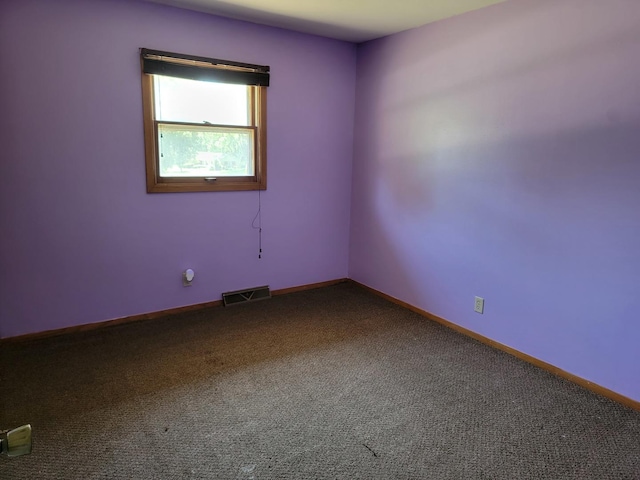 8788 Sheffield Dr, Belvidere, IL 61008 - empty room featuring dark colored carpet and baseboards