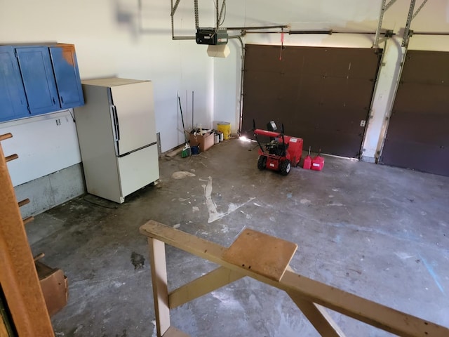 8788 Sheffield Dr, Belvidere, IL 61008 - garage featuring freestanding refrigerator and a garage door opener