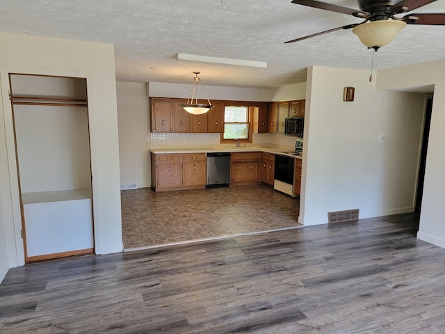 8788 Sheffield Dr, Belvidere, IL 61008 - kitchen featuring electric stove, stainless steel dishwasher, black microwave, wood finished floors, and light countertops