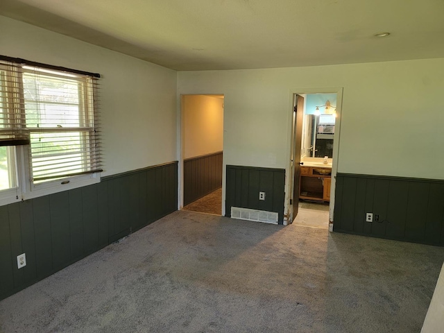 8788 Sheffield Dr, Belvidere, IL 61008 - unfurnished bedroom featuring wainscoting, carpet flooring, wood walls, and ensuite bathroom