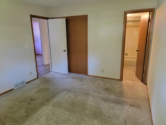 8788 Sheffield Dr, Belvidere, IL 61008 - unfurnished bedroom featuring carpet flooring, a closet, and ensuite bath