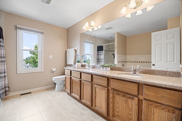 145 Barnes Rd, Elgin, IL 60124 - bathroom with a chandelier, tiled shower, double vanity, and tile patterned floors