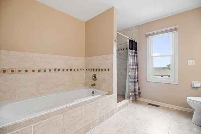 145 Barnes Rd, Elgin, IL 60124 - bathroom featuring a bath, tiled shower, and tile patterned flooring