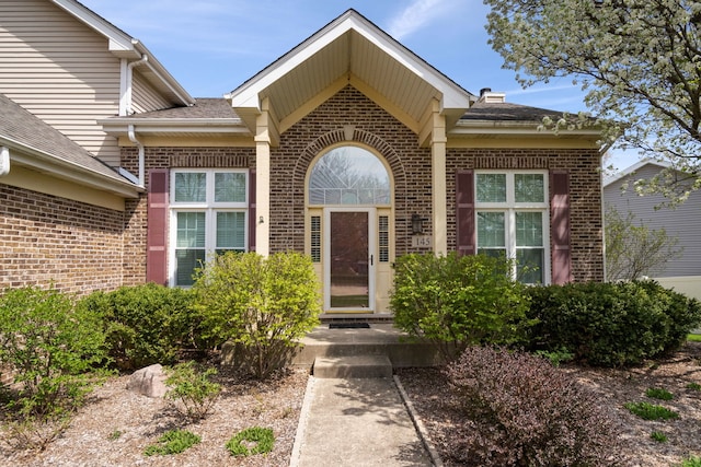 145 Barnes Rd, Elgin, IL 60124 - property entrance featuring brick siding and roof with shingles