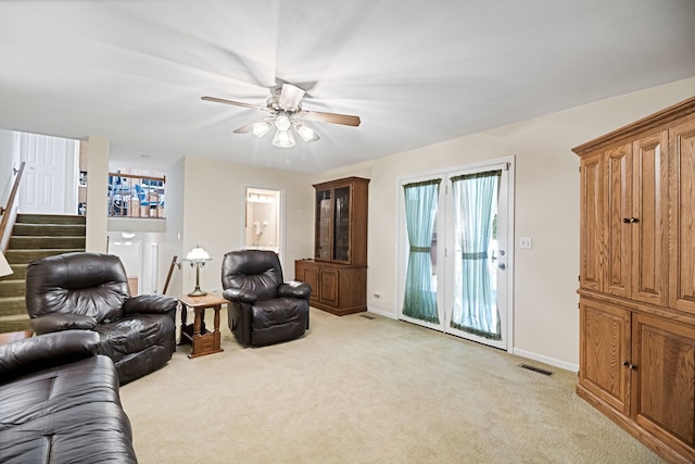 145 Barnes Rd, Elgin, IL 60124 - living area with light colored carpet, stairway, and a ceiling fan