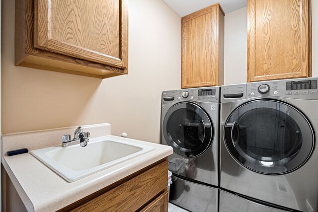 145 Barnes Rd, Elgin, IL 60124 - laundry area featuring cabinet space, washing machine and clothes dryer, and tile patterned flooring