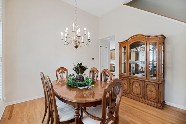 145 Barnes Rd, Elgin, IL 60124 - dining area featuring a chandelier, light wood-style floors, and high vaulted ceiling