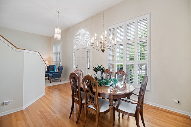 145 Barnes Rd, Elgin, IL 60124 - dining area with a chandelier, light wood-style flooring, and stairway