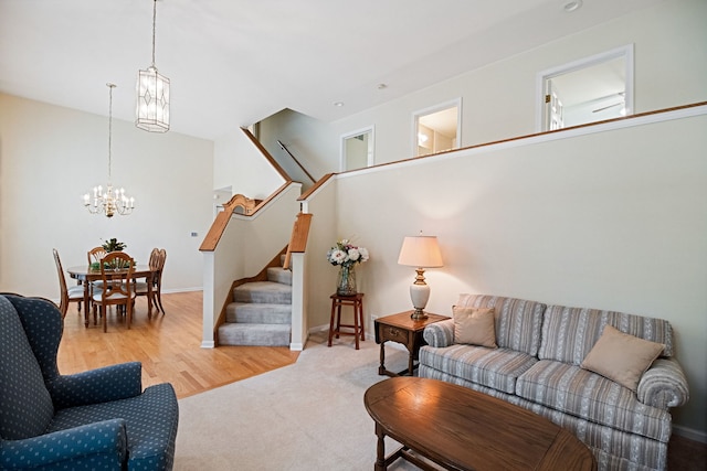 145 Barnes Rd, Elgin, IL 60124 - carpeted living room featuring a chandelier, stairs, and wood finished floors