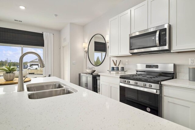 6455 Juniper Dr, Wonder Lake, IL 60097 - kitchen with appliances with stainless steel finishes, light stone counters, white cabinets, and recessed lighting
