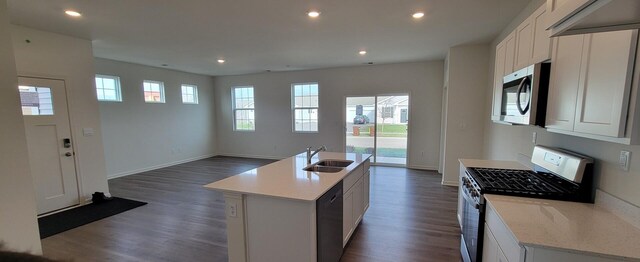 6455 Juniper Dr, Wonder Lake, IL 60097 - kitchen featuring gas stove, stainless steel microwave, dishwasher, open floor plan, and dark wood-type flooring