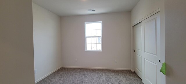 6455 Juniper Dr, Wonder Lake, IL 60097 - unfurnished bedroom with multiple windows, carpet flooring, and a closet