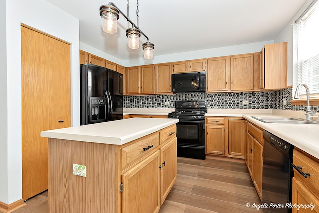 179 Cascade Dr, Crystal Lake, IL 60012 - kitchen featuring black appliances, decorative backsplash, light wood-style flooring, light countertops, and a kitchen island