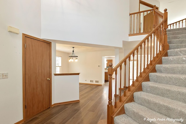179 Cascade Dr, Crystal Lake, IL 60012 - staircase with a high ceiling, wood finished floors, and a chandelier