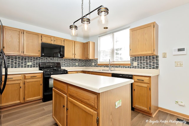 179 Cascade Dr, Crystal Lake, IL 60012 - kitchen featuring black appliances, light wood finished floors, decorative backsplash, and light countertops