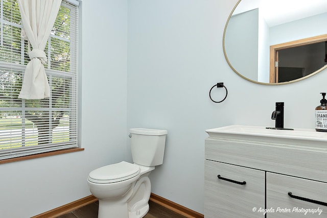 179 Cascade Dr, Crystal Lake, IL 60012 - half bathroom featuring vanity and wood finished floors