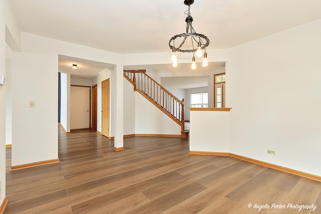 179 Cascade Dr, Crystal Lake, IL 60012 - spare room with stairs, wood finished floors, and a chandelier