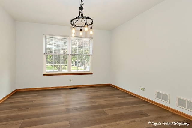 179 Cascade Dr, Crystal Lake, IL 60012 - spare room with a chandelier and wood finished floors